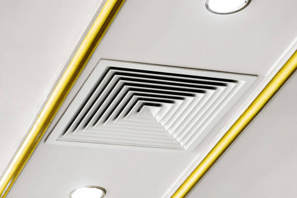 istock Square ventilation grill on the ceiling next to a spotlight 1319024683