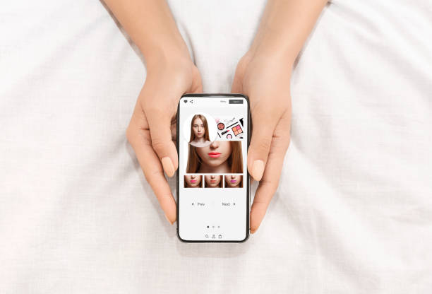 istock Augmented Reality Beauty App. Lady Trying Different Lipstick Color Online 1319024815