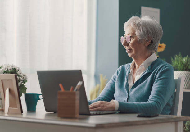 istock Senior lady using a laptop at home 1319024955