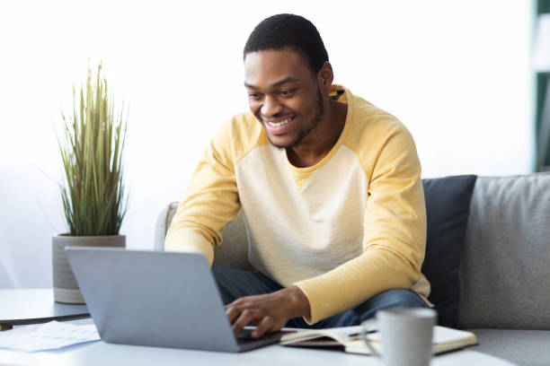 istock Positive black guy freelancer working online from home 1319025803