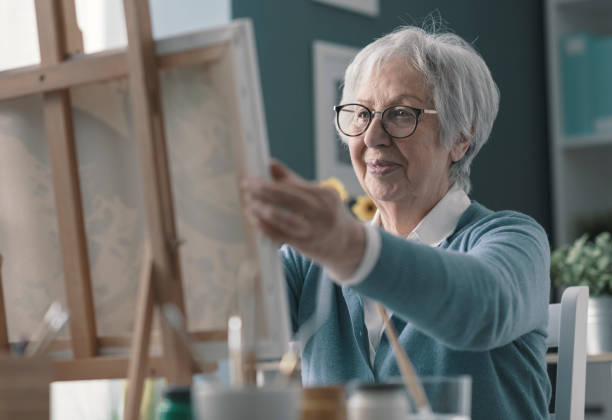 istock Happy senior lady looking at her finished artwork 1319026196