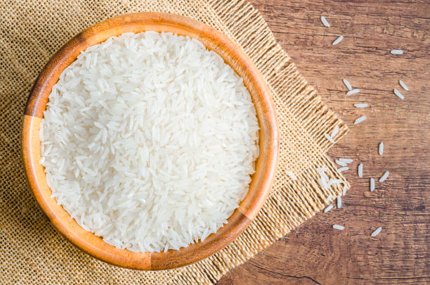 istock Organic Thai Jasmine rice grain in wooden bowl 1319026482