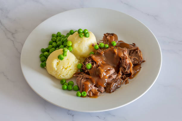 istock Butterflied beef with mashed potatoe and peas 1319027254