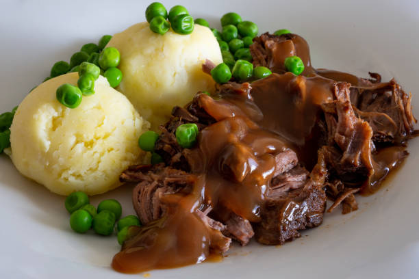 Butterflied beef with mashed potatoe and peas