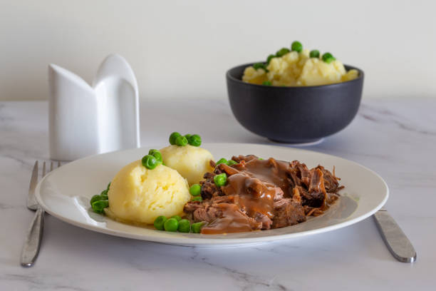 istock Butterflied beef with mashed potatoe and peas 1319027259