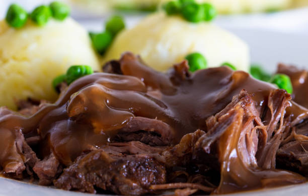 istock Butterflied beef with mashed potatoe and peas 1319027348