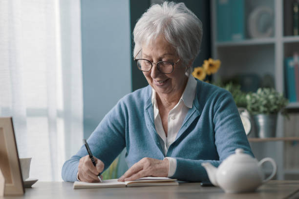 istock Senior woman writing on a notebook 1319027398