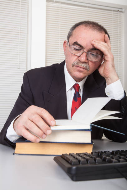 istock Businessman in office with books 1319027589