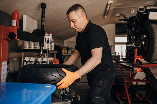 istock Male mechanic changing motorcycle tire 1319027631