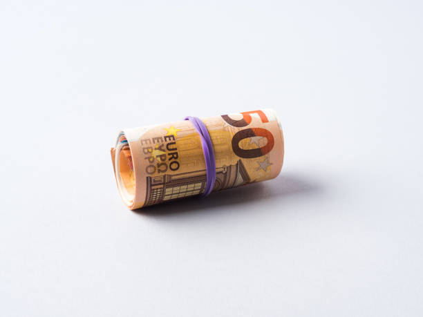 istock Euro 50 value banknotes roll with rubber on gray background 1319027947