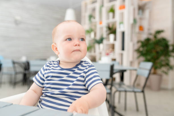 istock Cute little boy waits for a breakfast in cafe 1319027972