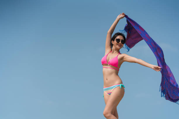 istock woman posing outdoors at the sea beach 1319029188