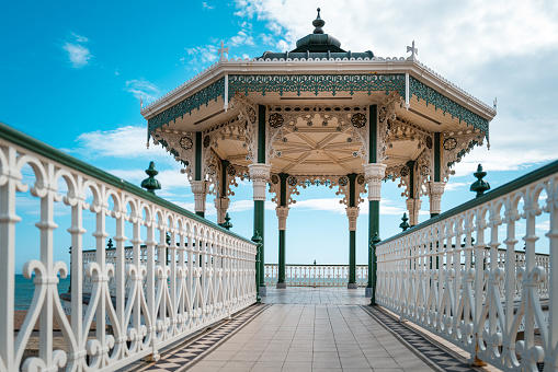 Color image depicting the traditional Victorian-style architecture of a bandstand in the southeast England town of Brighton.