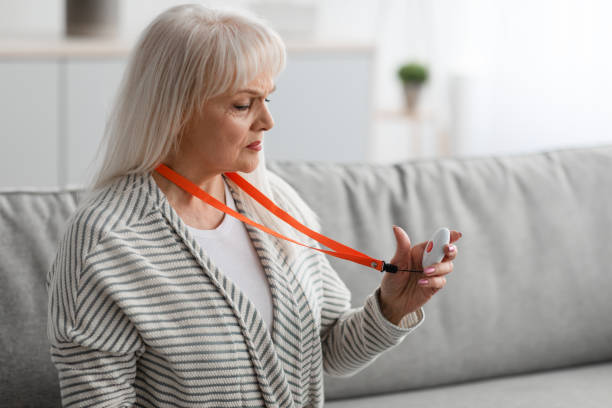 istock Emergency call system. Senior woman holding Alarm Button, closeup 1319030680