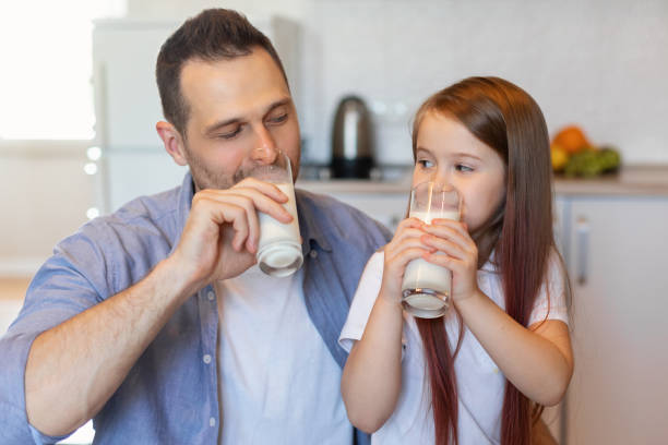 istock Father And Daughter Drinking Milk Enjoying Dairy Product In Kitchen 1319030733