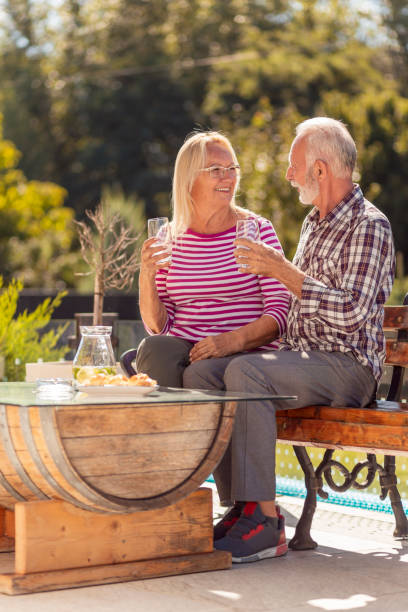 istock Senior couple relaxing and drinking lemonade in the backyard 1319030889