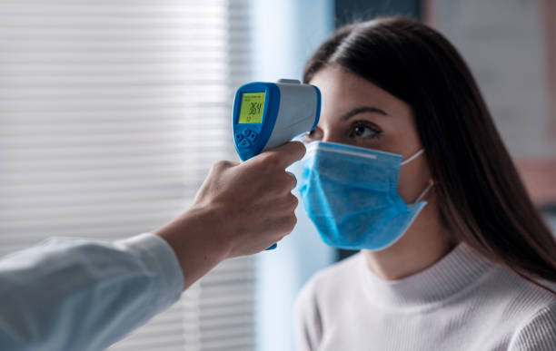 istock Body temperature check with infrared thermometer 1319030987