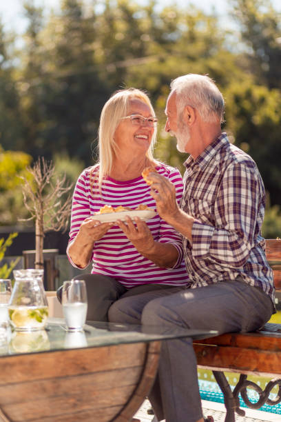 istock Senior couple having breakfast in the backyard 1319031141