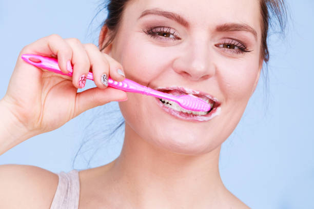 istock Woman brushing cleaning teeth 1319032479
