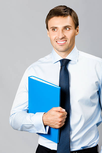 istock Portrait of business man with folder, over gray 131903327