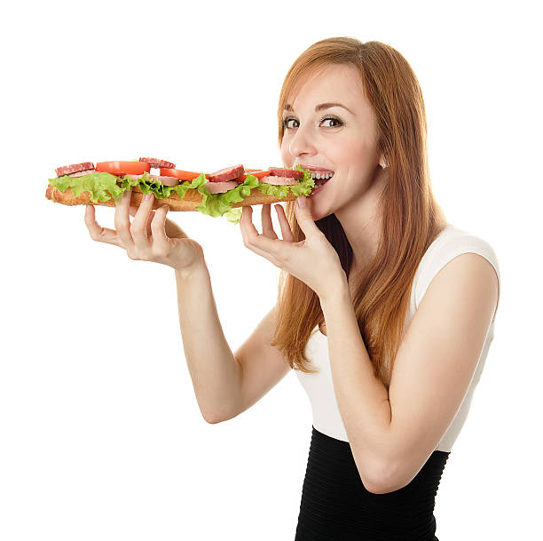 istock Young woman eating fast food 131903341