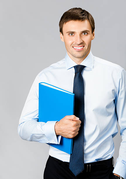 istock Portrait of business man with folder, over gray 131903345