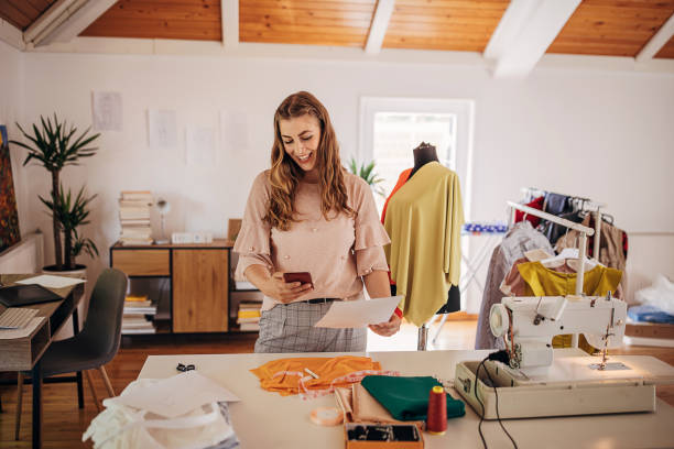 istock Female fashion designer using smart phone 1319034835