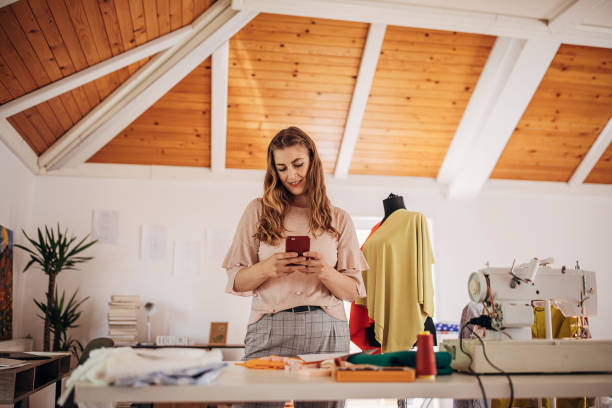 istock Female fashion designer using smart phone 1319034854