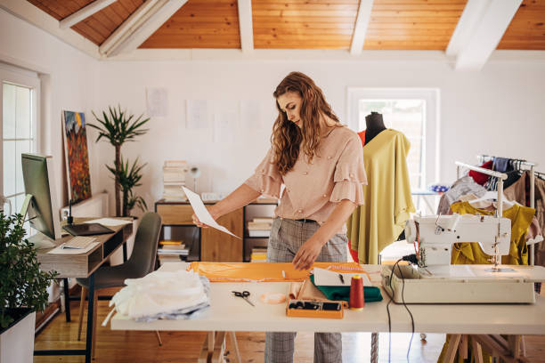 istock Female fashion designer in her studio 1319035459