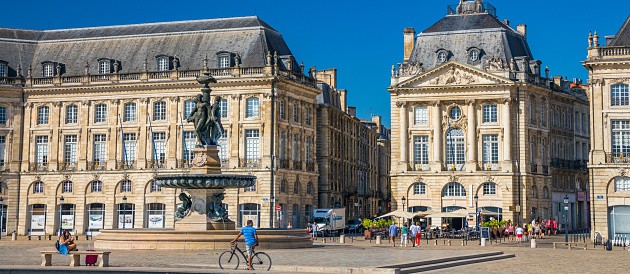 Place de la Bourse in Bordeaux France, view of Les Trois Graces, the famous fountain in the center of the square on a sunny day