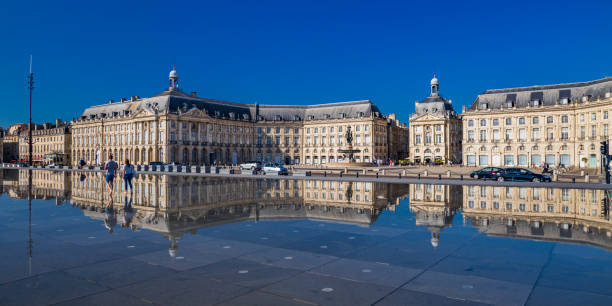 Historical building in Bordeaux reflected in a water pond acting as a mirror
