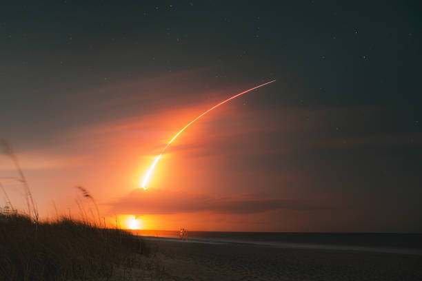 SpaceX Falcon 9 Rocket Launch from Melbourne Beach Long exposure night shot of a rocket launch from the beach at night rocket booster photos stock pictures, royalty-free photos & images