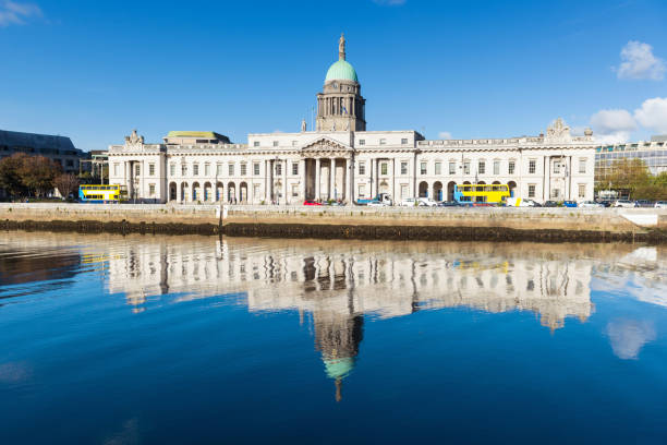 The Custom House, River Liffey, Dublin, Ireland Wide angle view of The Custom House reflected in the River Liffey on a calm blue morning in Dublin, Ireland dublin republic of ireland stock pictures, royalty-free photos & images