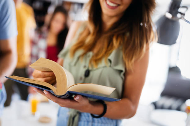 istock People, knowledge, education and school concept. Happy student girl with book 1319040050