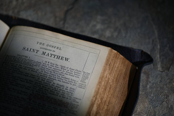 An Old Open Holy Bible on Stone Table Bckground stock photo