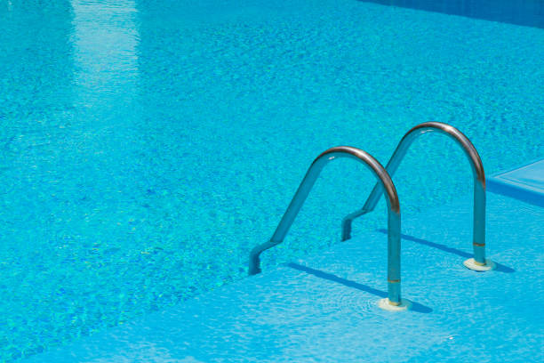 istock Swimming pool with stair and blue water. 1319042260