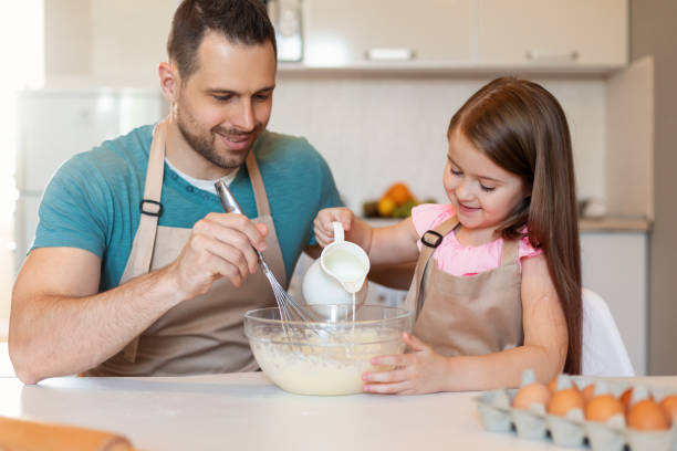 istock Cheerful Daughter And Dad Baking Cookies Together Making Dough Indoor 1319042613