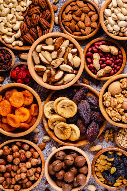 istock Various Nuts and dried fruits in wooden bowls 1319043270