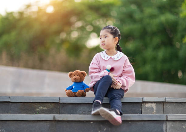 istock Cute Little Girl and Teddy Bear 1319044580