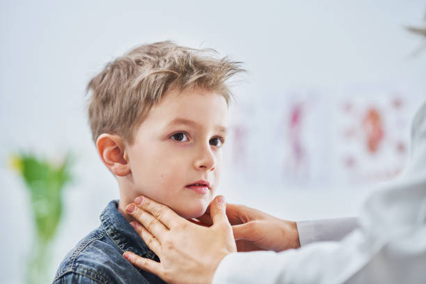 Little boy having medical examination by pediatrician stock photo