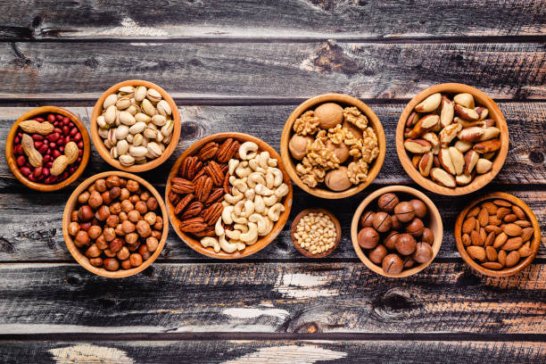 istock Various Nuts in wooden bowls 1319044725