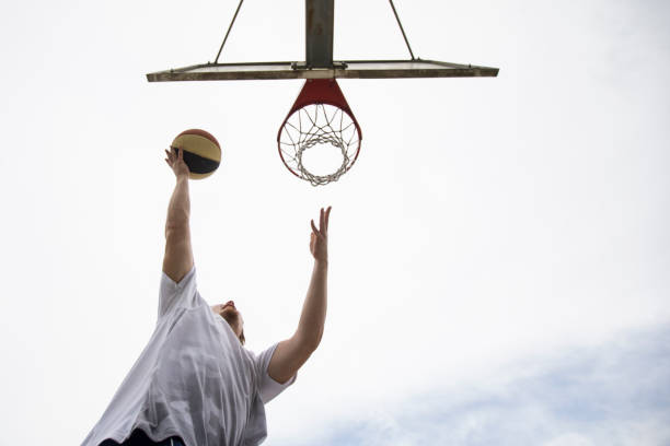 istock Low Angle View on Young Adult Man During Lay Up 1319045167