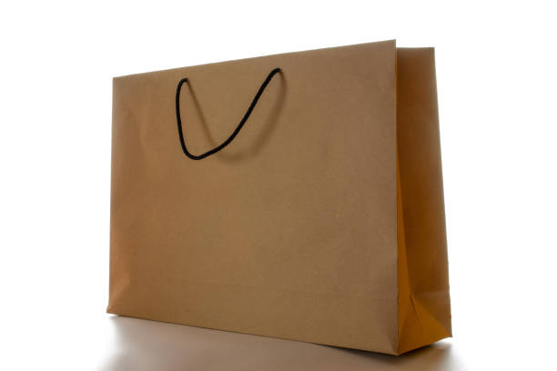istock Brown paper bag texture. Kraft recycle package with empty blank space for design mockup isolated on white background. Delivery service concept. Copy space. Advertising area. 1319045454