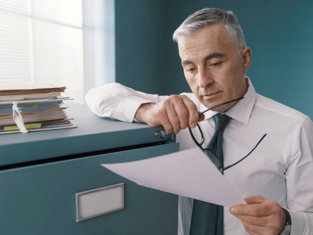 istock Business executive checking paperwork in the office 1319046275