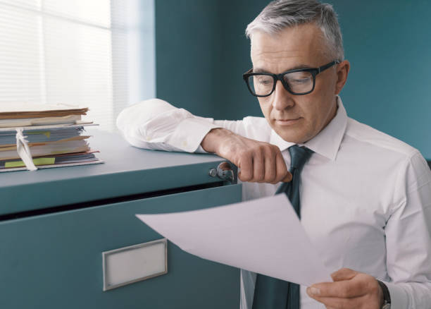 istock Business executive checking paperwork in the office 1319046597