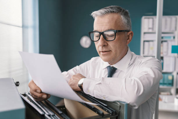 istock Businessman searching for files and documents 1319046789
