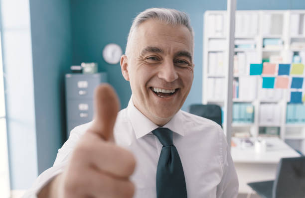 istock Cheerful executive giving a thumbs up 1319047568