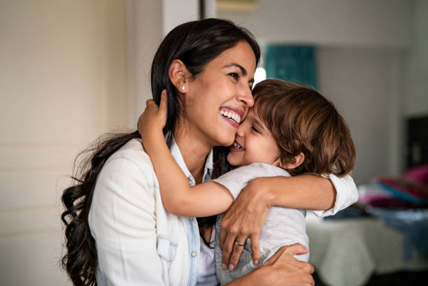 Mother and son embracing each other at home