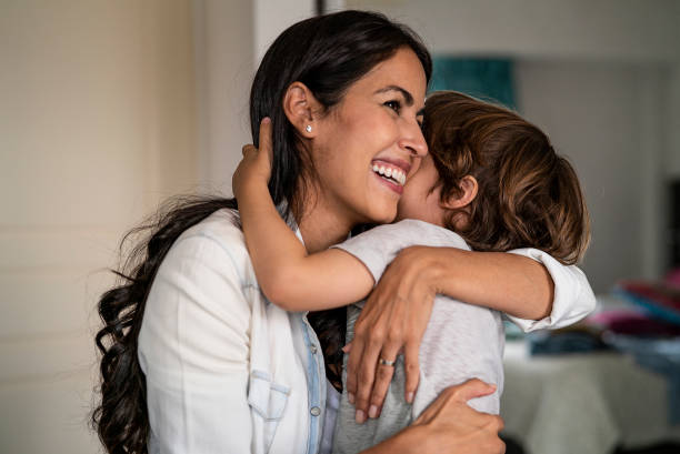 istock Mother and son embracing each other at home 1319049230