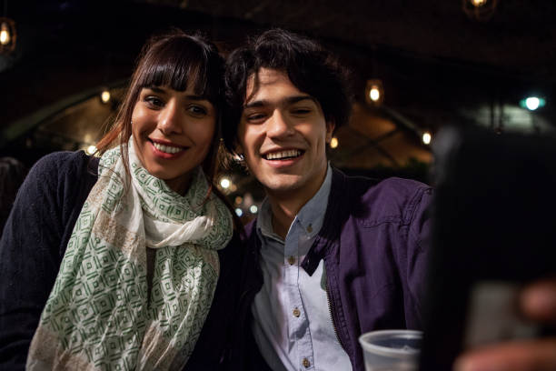 istock Happy friends taking a selfie in bar at night 1319050115